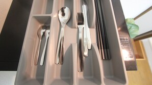 A compartmentalized drawer with utensils including a spoon, fork, knife, and chopsticks. - Small-Town Feel, Big-City Access | Homey Stay in Nakano (Nogata, Nakano-ku)