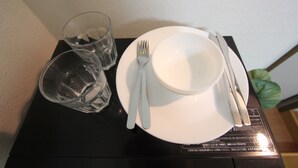 A table with a white plate, a fork, a knife, and two glasses. - Small-Town Feel, Big-City Access | Homey Stay in Nakano (Nogata, Nakano-ku)