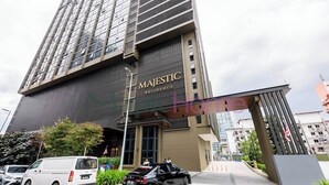 Un edificio moderno con una entrada destacada que dice "MAJESTIC RESIDENCE".