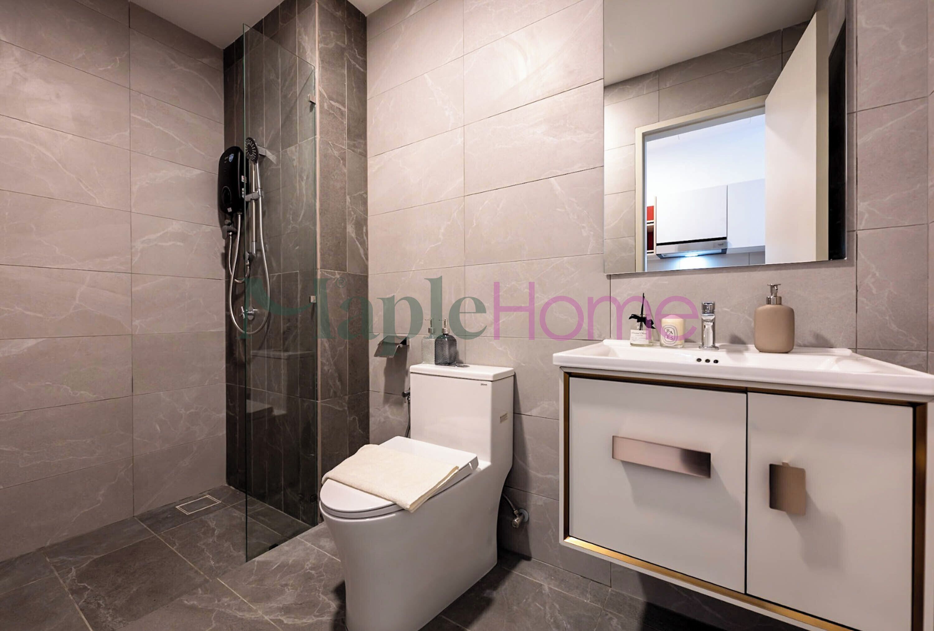 A modern bathroom with a glass-enclosed shower, a toilet, and a vanity with a mirror and sink.