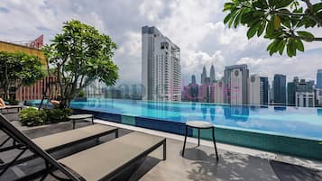 Outdoor pool, open 7:00 AM to 10:00 PM, pool loungers