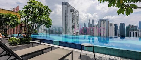 Outdoor pool, open 7:00 AM to 10:00 PM, pool loungers