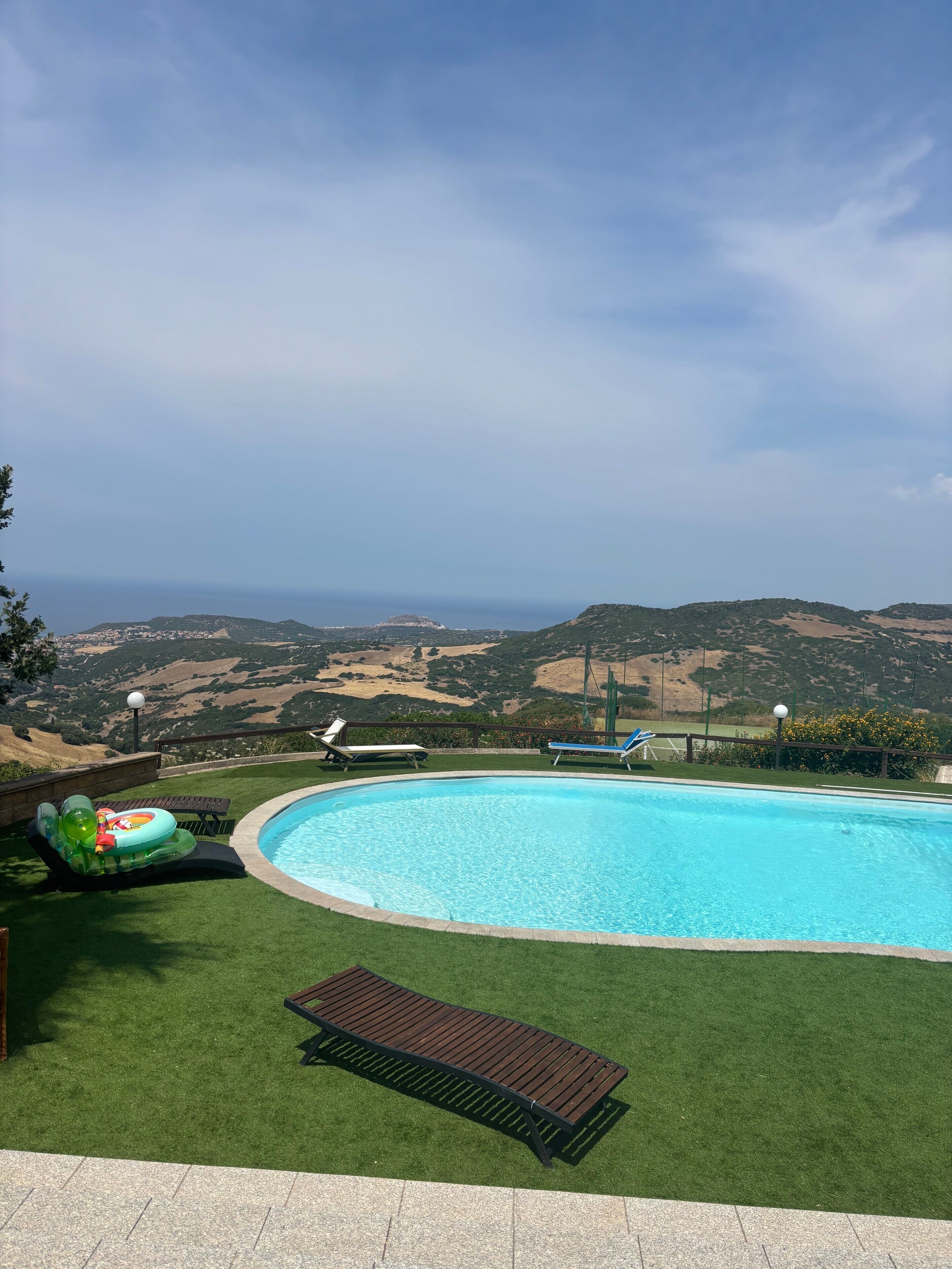 A swimming pool with a view of the countryside.