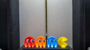 A black platform with four colorful, pixelated figures.