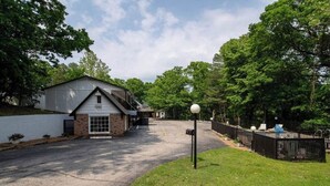 A residential property with a garage, a fenced yard, and a mailbox. - KC Room, #7 at Glory Dayz! (Eureka Springs)