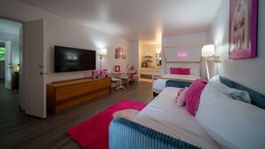A modern bedroom with a TV, a desk, a bed, and a neon sign. - Pink Room, #16 at Glory Dayz! (Eureka Springs)