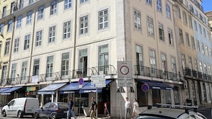 Un edificio de varios pisos con un estilo arquitectónico clásico, que cuenta con balcones y ventanas amplias.