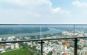 A cityscape with a river, buildings, and a clear sky. - The Parkland Lux & Easy in East Tower (Ho Chi Minh City)