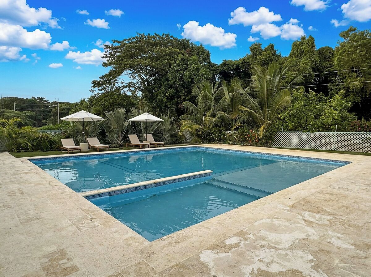 Private resort-style pool surrounded by lush tropical gardens.