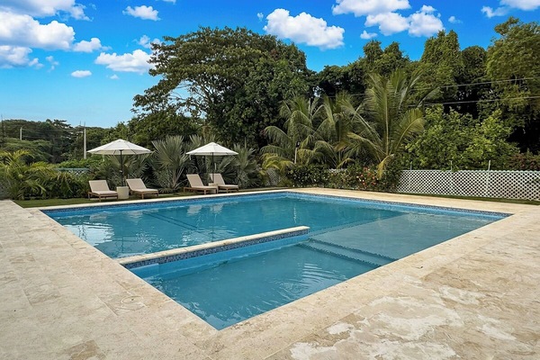 Private resort-style pool surrounded by lush tropical gardens.