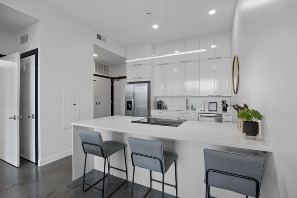 Fridge, microwave, oven, stovetop - Chic Downtown Condo Steps from UIowa & Nightlife (Iowa City)