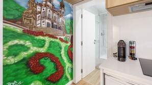 A room with a mural of a building and a coffee maker on the counter. - Liberty Braga Apartment by Minho s Guest (Braga)