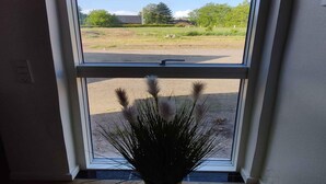 A window with a view of a grassy area and a building in the distance. - 5 Star Holiday Home in Galten (Galten)
