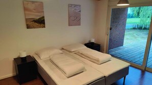 A bedroom with a bed, two bedside tables, a lamp, and a view of the outdoors. - 5 Star Holiday Home in Galten (Galten)