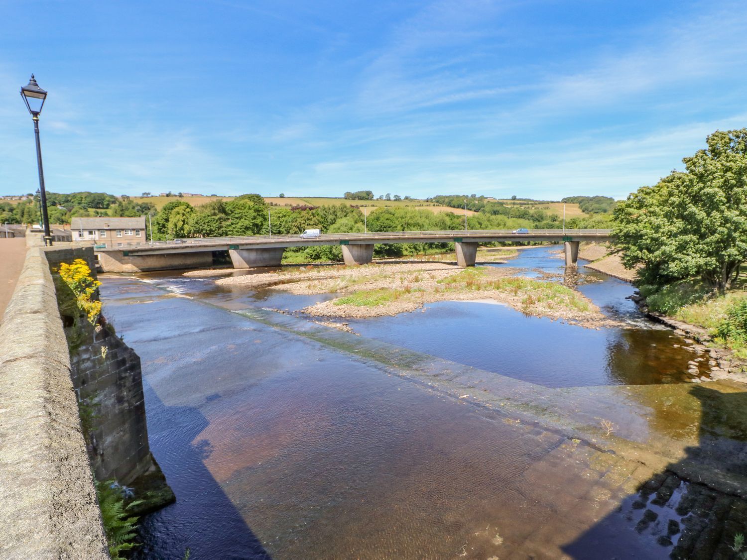 A bridge over a river with a clear sky.