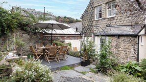 A stone house with a patio, outdoor seating, and a garden. - Stylish luxurious 5 bedroom house, central Lynton (Lynton)