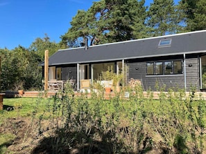 A modern house with a covered porch, a chimney, and a large window. - 5 Star Holiday Home in Vejby (Vejby)