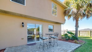 A patio with a brick floor, two tables, and four chairs. - Games, Bikes & Kids Play Area: Ocala Family Home (Ocala)