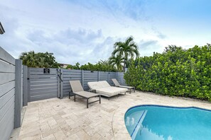 An outdoor pool area with lounge chairs and a pool. - Walkable Island City Oasis w/ Private Heated Pool! (Wilton Manors)