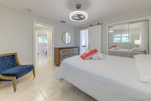 A bedroom with a bed, a chair, a dresser, and a mirror. - Walkable Island City Oasis w/ Private Heated Pool! (Wilton Manors)