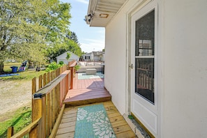 A wooden deck leading to a white house with a sliding glass door. - 2 Mi to Dtwn Newark: Pet-friendly Home! (Newark)