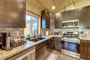 A modern kitchen with dark wood cabinets, stainless steel appliances, and a granite countertop. - Big Bear Mtn Fun: Family Cabin w/ Game Room (Sugarloaf)