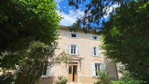 A two-story building with a central entrance, surrounded by dense greenery. - Le Clos 1003 (Saint-Didier-sur-Chalaronne)