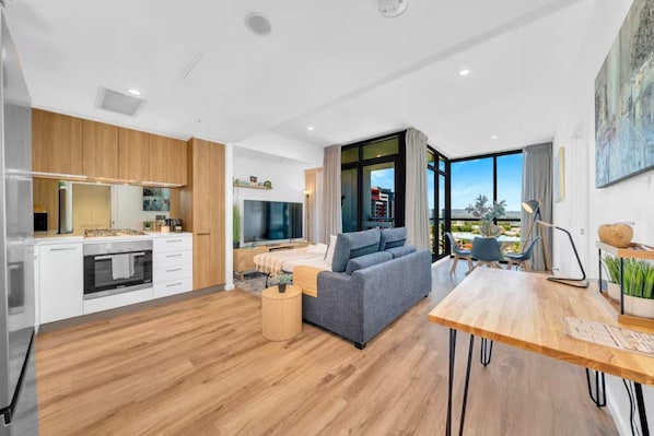 A modern apartment with a kitchen, living area, and dining space.