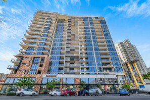 A multi-story building with a mix of residential and commercial spaces, including a local grocery store on the ground floor.