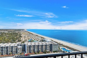 A beachfront hotel with multiple floors, a swimming pool, and a view of the ocean. - Myrtle Beach Resort RT1717 (Myrtle Beach)