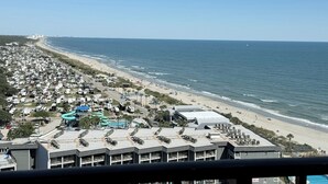 A coastal area with a beach, RV parking, and a building with a pool. - Myrtle Beach Resort RT1717 (Myrtle Beach)