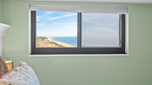 A room with a large window overlooking a beach. - Myrtle Beach Resort RT1717 (Myrtle Beach)