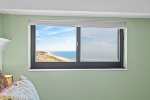 A room with a large window overlooking a beach. - Myrtle Beach Resort RT1717 (Myrtle Beach)