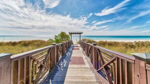 A wooden boardwalk leading to a beach with a gazebo at the end. - Lagoon Lookout 811-Gulf-Front Views-Sleeps 6 (Panama City Beach)