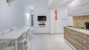 A modern kitchen with a tiled backsplash, a built-in oven, and a sink. - Spacious Paceville fully equipped home w/WIFI (St. Julian`s)