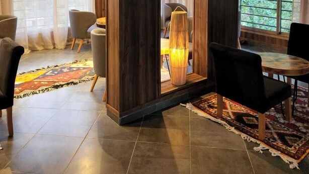 Ein modernes Wohnzimmer mit großem Fenster, Essbereich und gemütlicher Sitzecke.