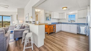 A modern kitchen with white cabinets, a wooden countertop, and a built-in dishwasher. - Oceanfront Home in Avon with Hot Tub and Stunning Views (Avon)