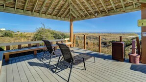 A wooden deck with two chairs and a bench, overlooking a beach and dunes. - Top Floor Ocean View! | Island Club 1502 (Hilton Head Island)