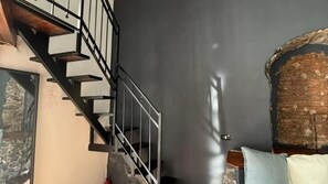 A staircase with a metal railing leading to a lower level. - 200m Monastero Benedettini Loft in historic center (Catania)