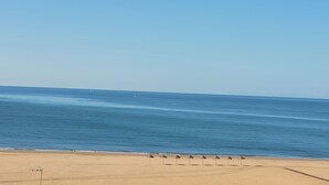 A beach with a clear sky and calm sea. - CANELA BEACH DREAM, PENTHOUSE ON THE SEA (Isla Canela)