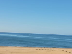 On the beach, sun-loungers