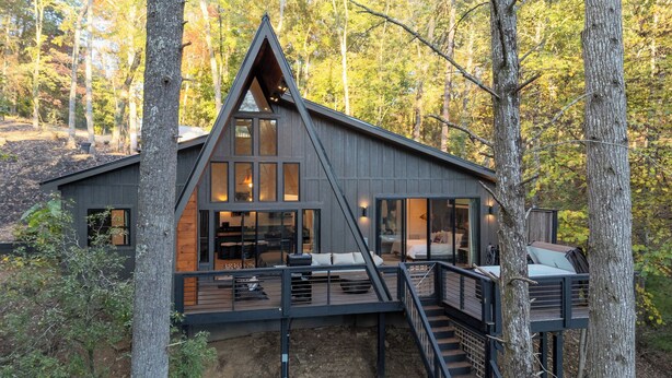 A modern cabin with a triangular roof, large windows, and a deck area. - A Place and Time Blue Ridge GA (Blue Ridge)