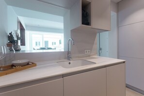 A modern kitchen with a white countertop, a stainless steel sink, and a built-in oven. - A three-bedroom in Tetuán with its own outdoor space and a separate guest house with a workspace, near La Ventilla park and the Castellana. (MADRID)