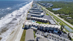 A coastal hotel with a beachfront view, multiple buildings, and a parking area. - Seaward B101 (New Smyrna Beach)