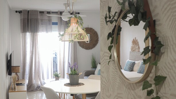 Un espace repas moderne avec une table ronde, des chaises à revêtement gris et un luminaire suspendu.