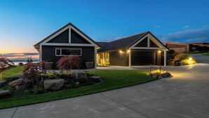 A modern two-story house with a well-maintained lawn and driveway.