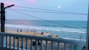 Un balcón con vista a la playa y el océano.