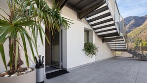 A modern building with a staircase, a potted plant, and a door. - Eco del Garda - Room 102 - Ground Floor, Mountain View (Tenno)