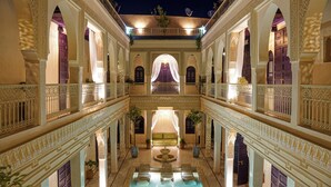 A luxurious hotel interior with a central courtyard, ornate balconies, and a pool area. - Palais Andara Riad And SPA (Marrakech)