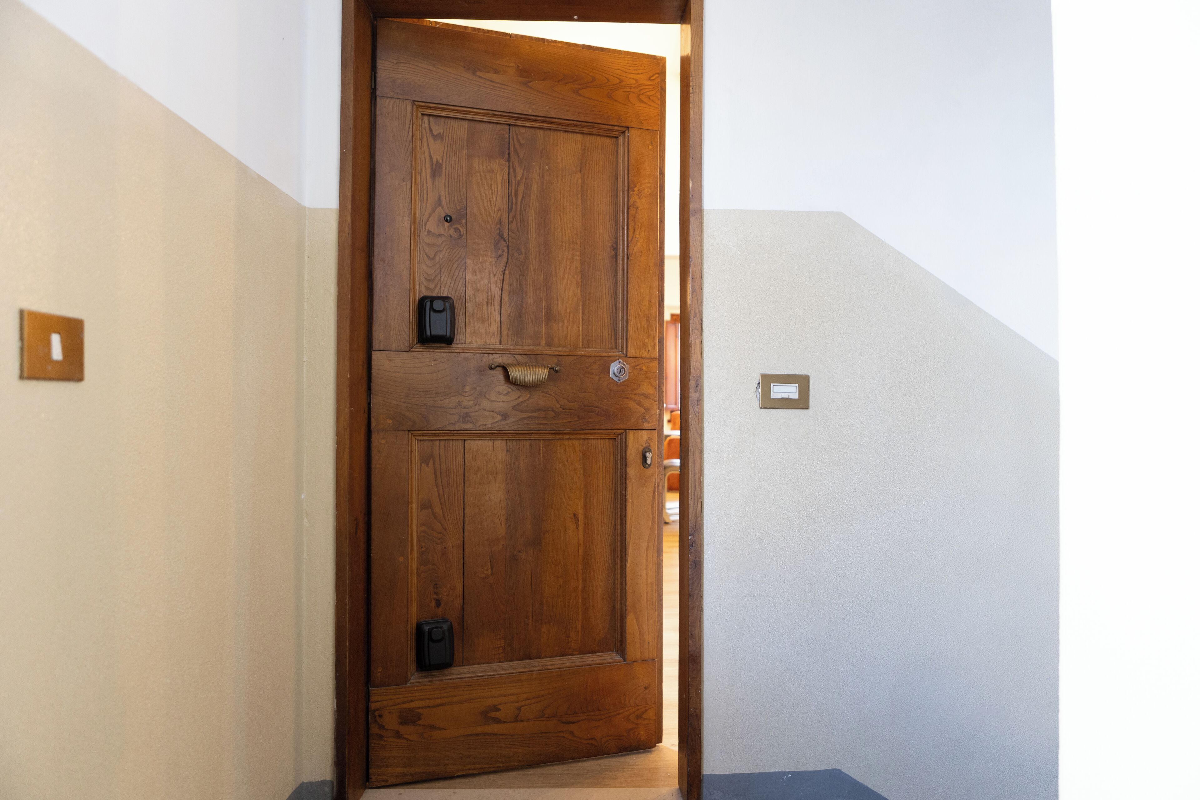 A wooden door with a handle and a lock.